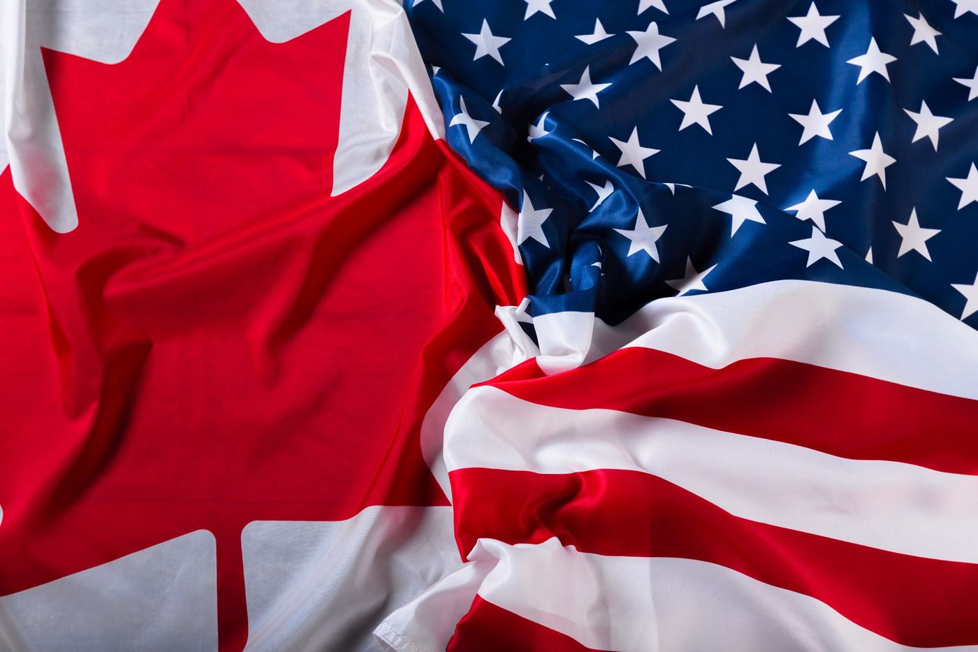 The flags of Canada and the United States side by side